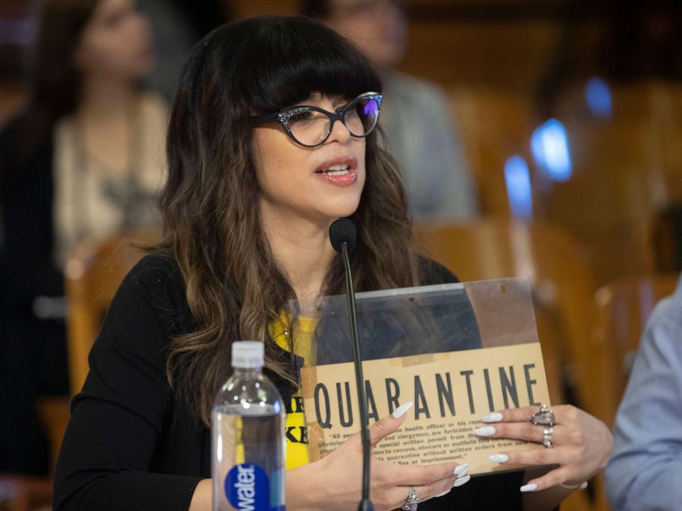 PHOTO: City of Milwaukee Health Commissioner Jeanette Kowalik holds a sign from the 1940s while speaking at a Public Safety and Health Committee meeting about coronavirus preparations, March 5, 2020, at City Hall.


