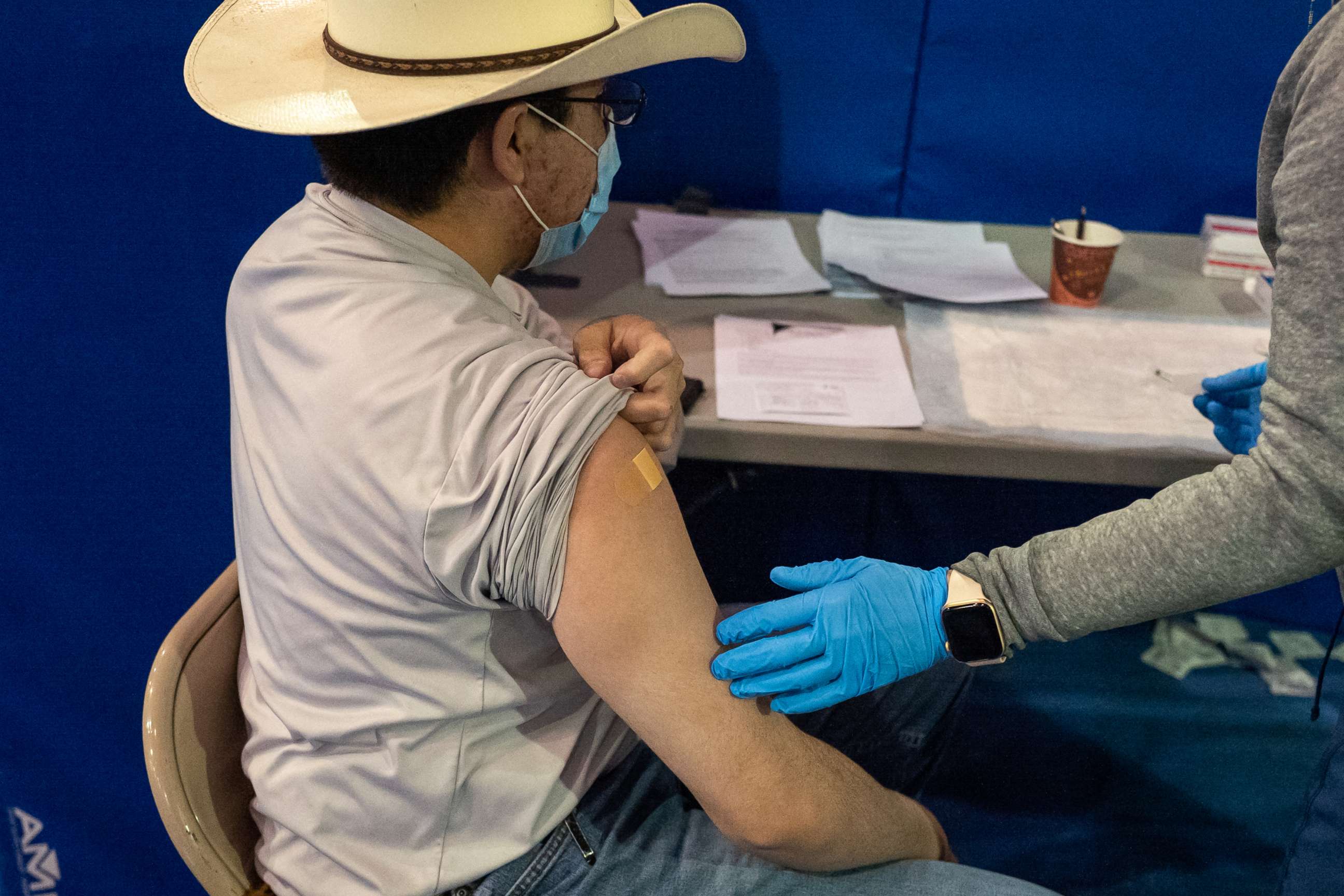 PHOTO: A healthcare worker speaks with a person that received a second dose of the Pfizer-BioNTech COVID-19 vaccine at the University of New Mexico's Gallup campus in Gallup, N.M., March 23, 2021.
