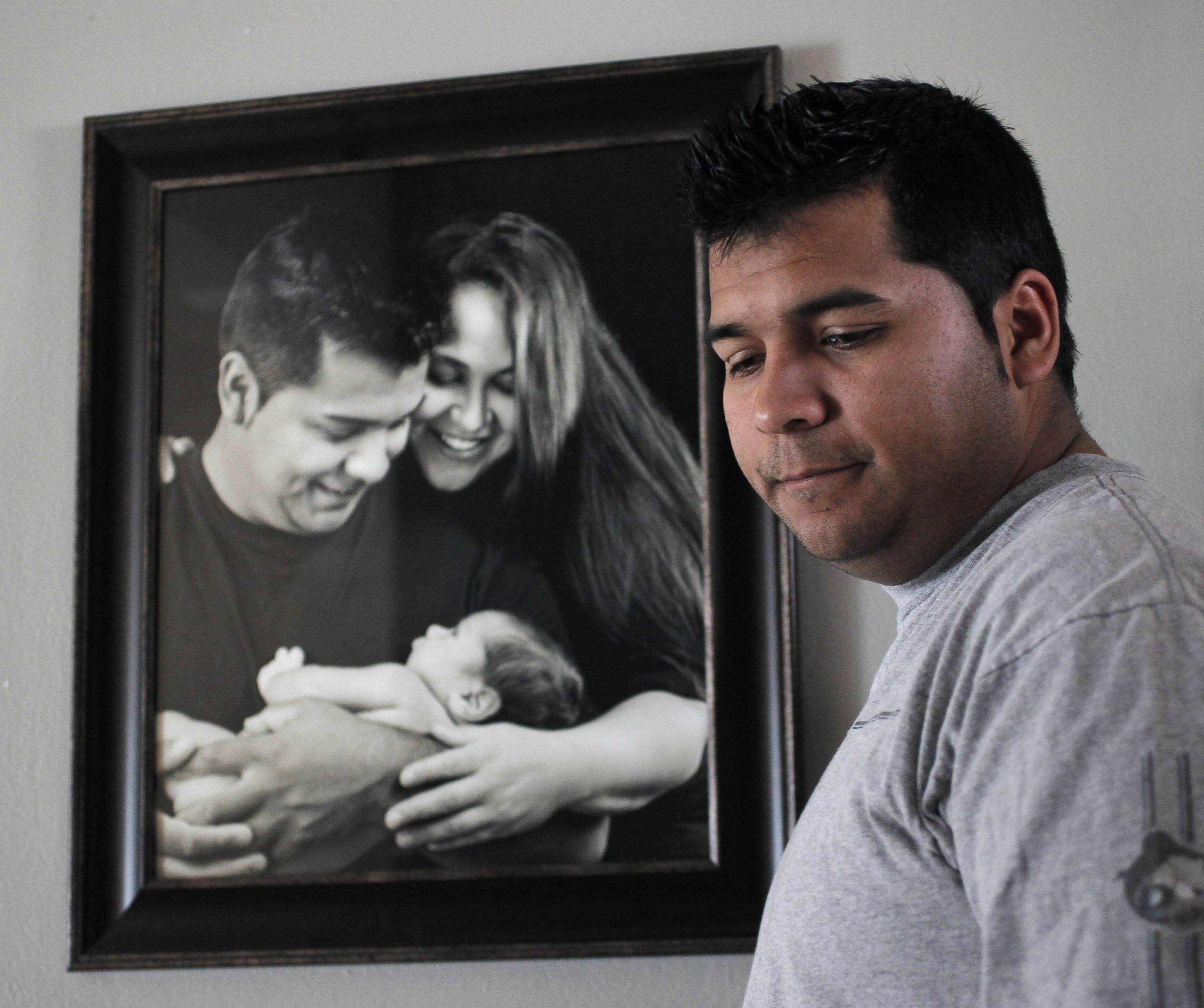 PHOTO: Erick Munoz, the husband of Marlise Munoz, stands near a photo of himself and his wife