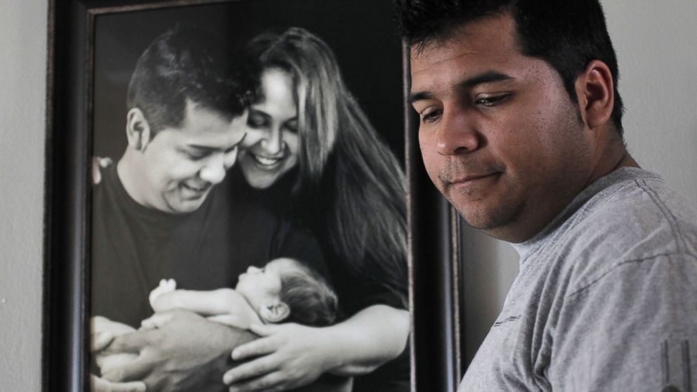 PHOTO: Erick Munoz, the husband of Marlise Munoz, stands near a photo of himself and his wife