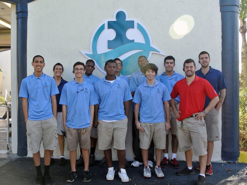 Employees of Rising Tide Car Wash pose for a photo