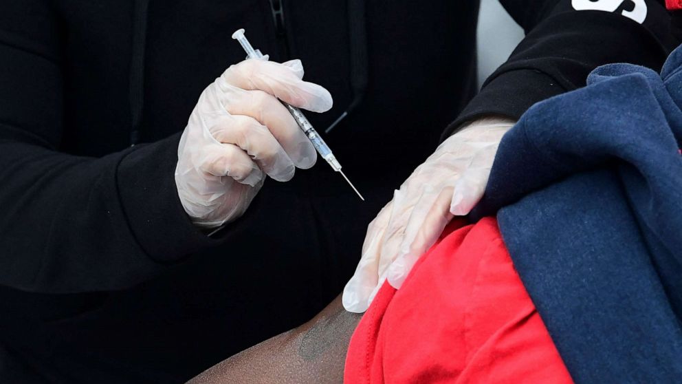 PHOTO: People receive the Pfizer COVID-19 vaccine at a public housing project pop-up site targeting vulnerable communities in Los Angeles, March 10, 2021. 