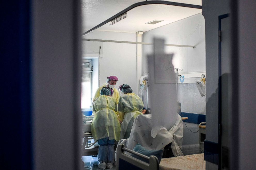 PHOTO: Health workers attend to a patient at the Covid-19 ward of the Curry Cabral hospital in Lisbon on November 18, 2020. - Pfizer and BioNTech said that a completed study of their experimental Covid-19 vaccine showed it was 95 percent effective. 