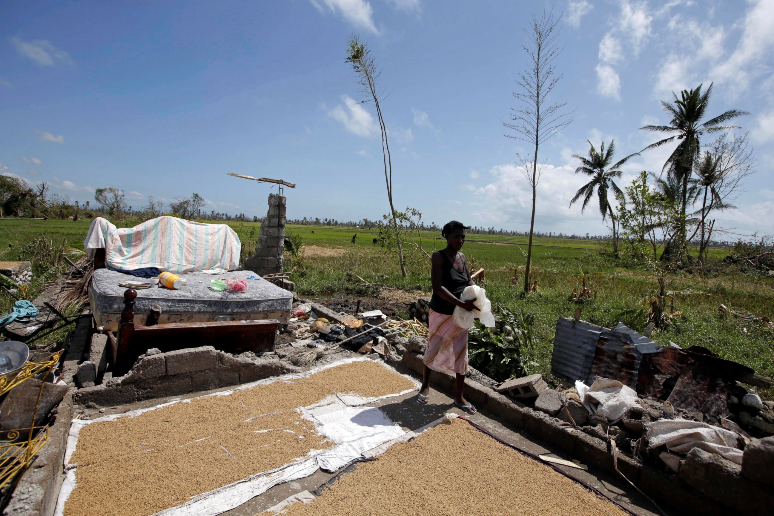 PHOTO: A woman walks on the remains of her house destroyed by Hurricane Matthew on the outskirts of Les Cayes, Haiti, Oct. 7, 2016. 