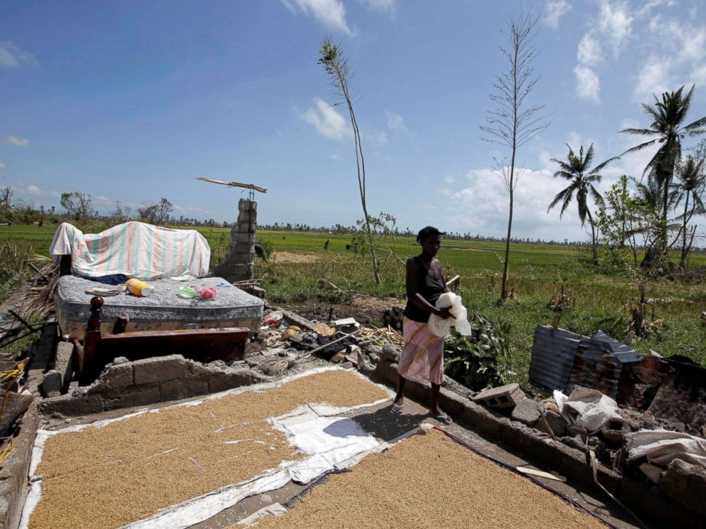 PHOTO: A woman walks on the remains of her house destroyed by Hurricane Matthew on the outskirts of Les Cayes, Haiti, Oct. 7, 2016.