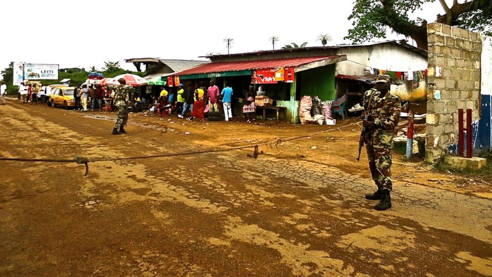 Soldiers from the Liberian army monitor a border checkpoint as part of Operation White Shield to control the Ebola outbreak, at an entrance to Bomi County in northwestern Liberia August 11, 2014.