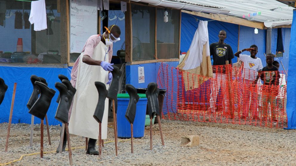 PHOTO: People stand in the "red zone" where they are being treated for Ebola at the Bong County Ebola Treatment Unit in Monrovia, Liberia, Oct. 28, 2014.