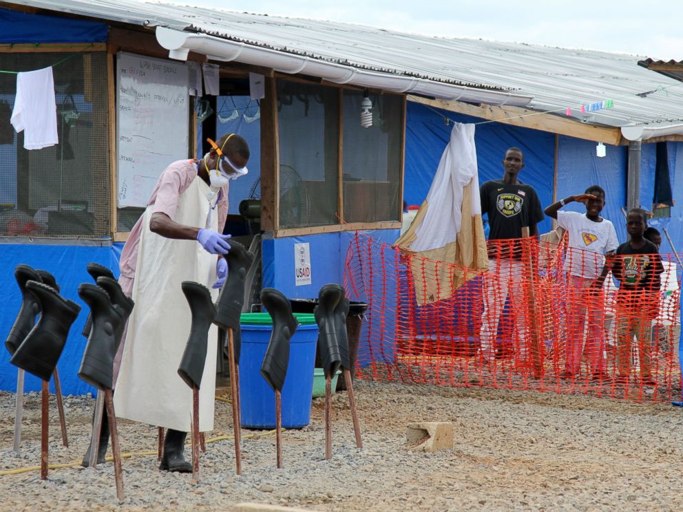 PHOTO: People stand in the red zone where they are being treated for Ebola at the Bong County Ebola Treatment Unit in Monrovia, Liberia, Oct. 28, 2014.