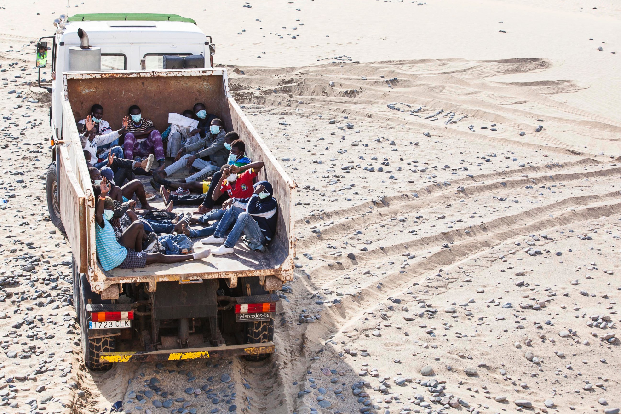 PHOTO: People who arrived on a fishing boat sit inside a truck at Maspalomas beach on Gran Canaria in Spain's Canary Islands, Nov. 5, 2014. 