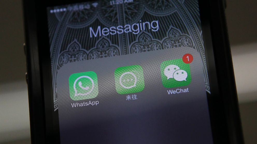 Icons of messaging applications WhatsApp of Facebook, Laiwang of Alibaba Group  and WeChat, or Weixin, of Tencent Group, are seen on the screen of a smart phone on this photo illustration taken in Beijing, Feb. 24, 2014.