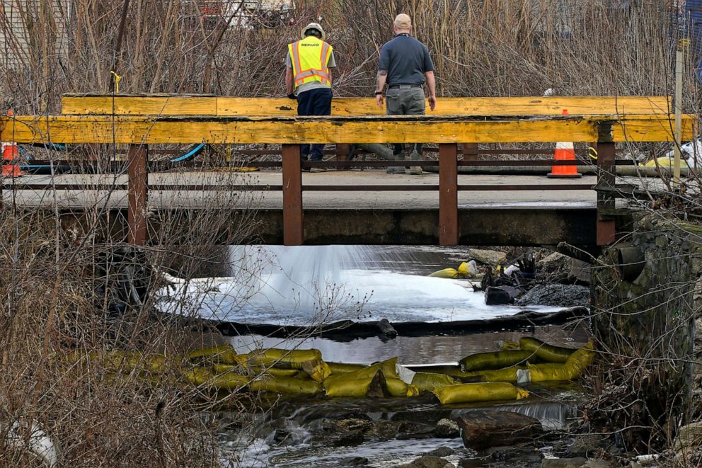 PHOTO: HEPACO workers, an environmental and emergency services company, observe a stream in East Palestine, Ohio, Feb. 9, 2023, as the cleanup continues after the derailment of a Norfolk Southern freight train.