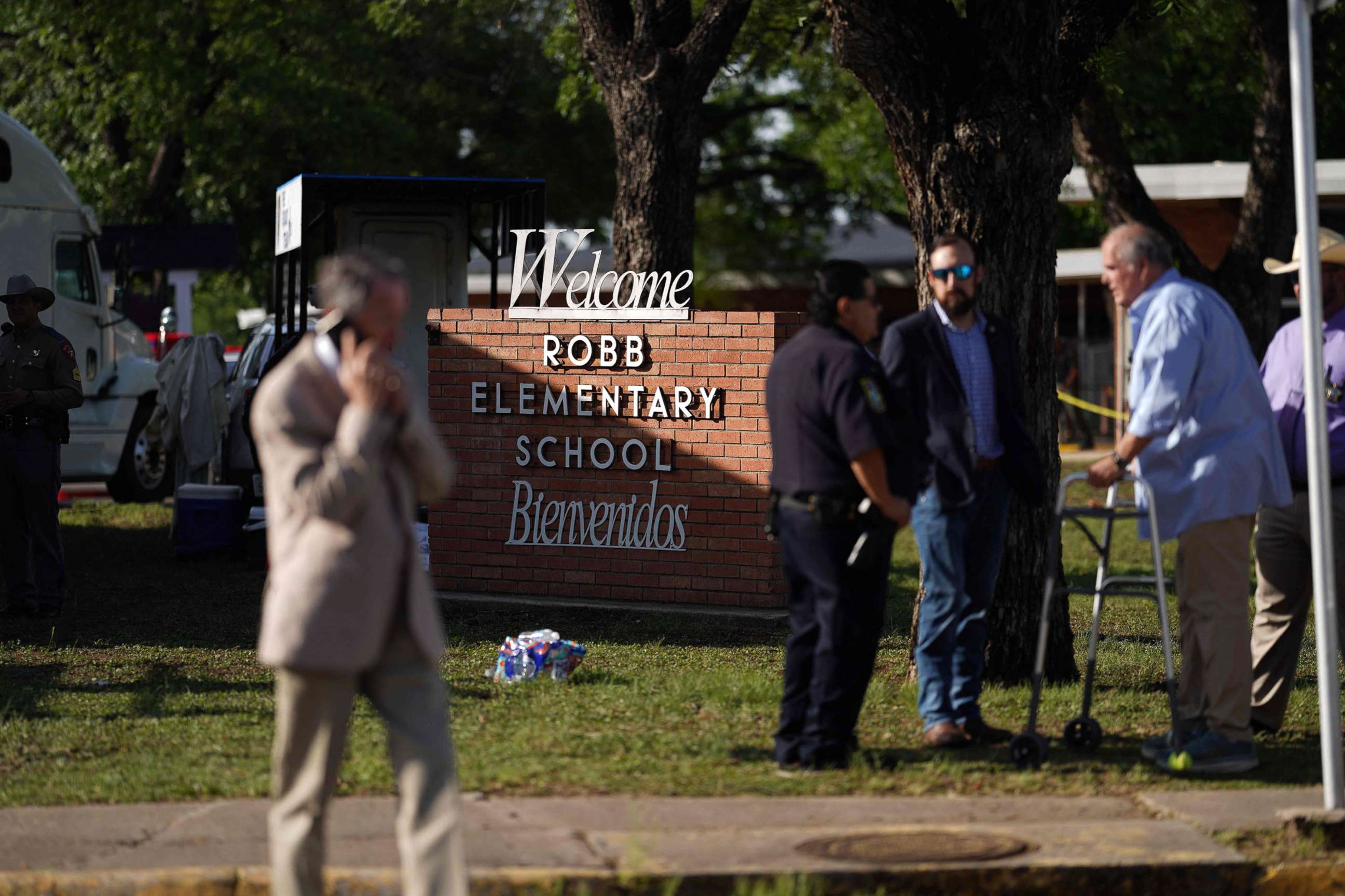 PHOTO: People stand outside Robb Elementary School in Uvalde, Texas, May 25, 2022. 