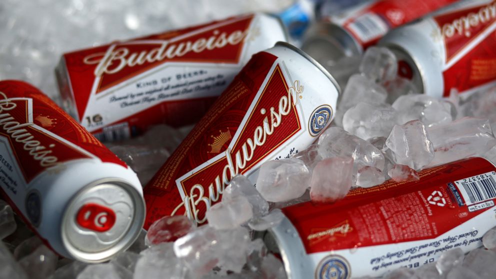 FILE - In this March 5, 2015, file photo, Budweiser beer cans are on ice at a concession stand at McKechnie Field in Bradenton, Fla. The maker of Budweiser is partnering with medical cannabis company Tilray in a $100 million deal to research cannabis
