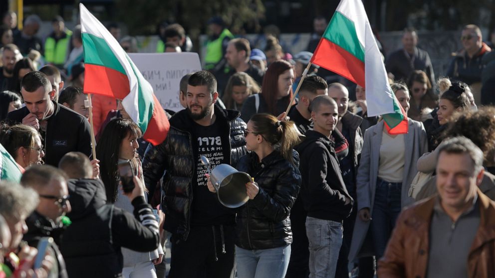 Protesters carry Bulgarian flags and make noise using restaurant equipment during a national protest of restaurant owners, chefs, waiters, and bartenders, in Sofia, Bulgaria, Thursday Oct. 28, 2021. Thousands people took to the streets in many cities