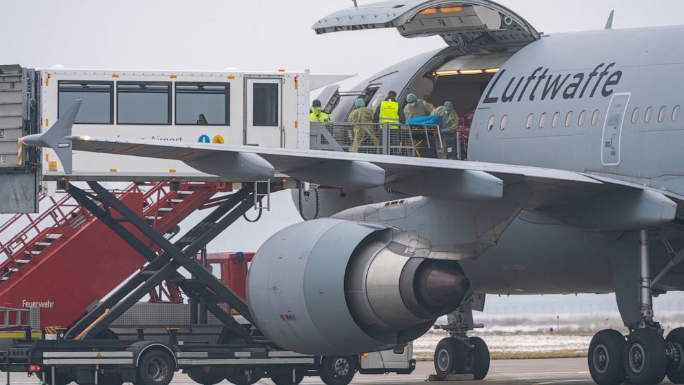 A Bundeswehr aircraft stands with its side flap open at the airport in Memmingen, Germany, Friday, Nov. 26, 2021. The German air force Luftwaffe will begin assisting the transfer of intensive care patients from hospitals in Bavaria to northern German