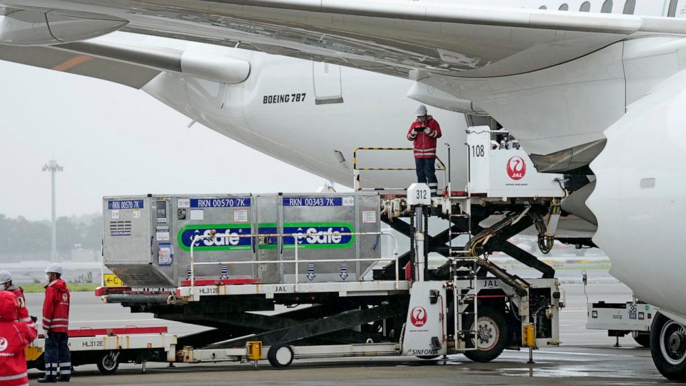 The containers carrying the coronavirus vaccines donated by Japanese government, are loaded to a plane before its departure for Taiwan, at Narita International Airport in Narita, east of Tokyo, Friday, June 4, 2021. Japan is donating 1.24 million dos