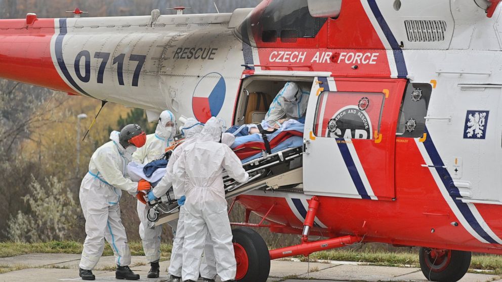 Health workers at the Motol University Hospital take out of army helicopter one of the patients with COVID-19, who was transported to Prague from a hospital in Brno, Czech Republic, Thursday, Nov. 25, 2021. COVID spread reaches another record in Czec