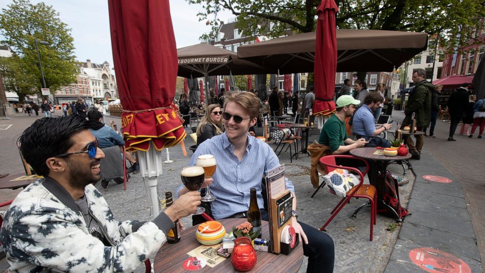 People toast as terraces reopened at midday in Utrecht, Netherlands, Wednesday, April 28, 2021. The Netherlands became the latest European country to begin cautiously relaxing its lockdown even as infection rates and intensive care occupancy remain s