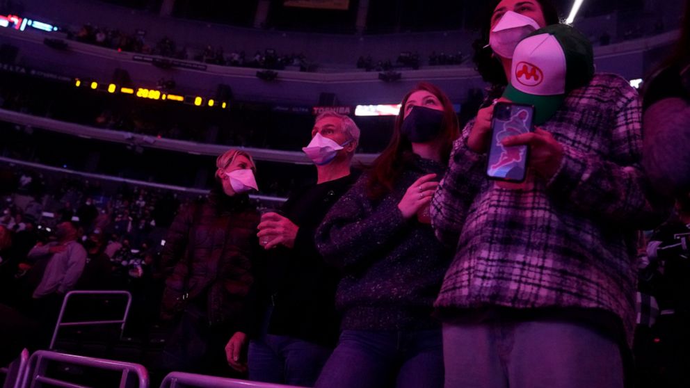Fans wear masks inside crypto.com Arena before an NHL hockey game between the Los Angeles Kings and the Nashville Predators Thursday, Jan. 6, 2022, in Los Angeles. (AP Photo/Marcio Jose Sanchez)