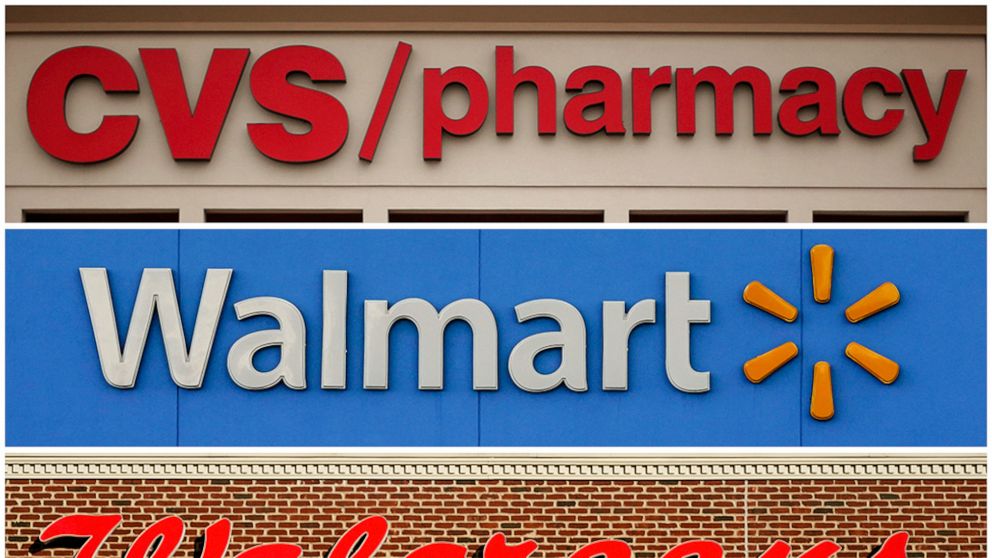 FILE - This undated combination of file photos show the signs of CVS, Walmart and Walgreens. A federal judge in Cleveland awarded $650 million in in damages on Wednesday, Aug. 17, 2022, to two Ohio counties that won a landmark lawsuit against nationa