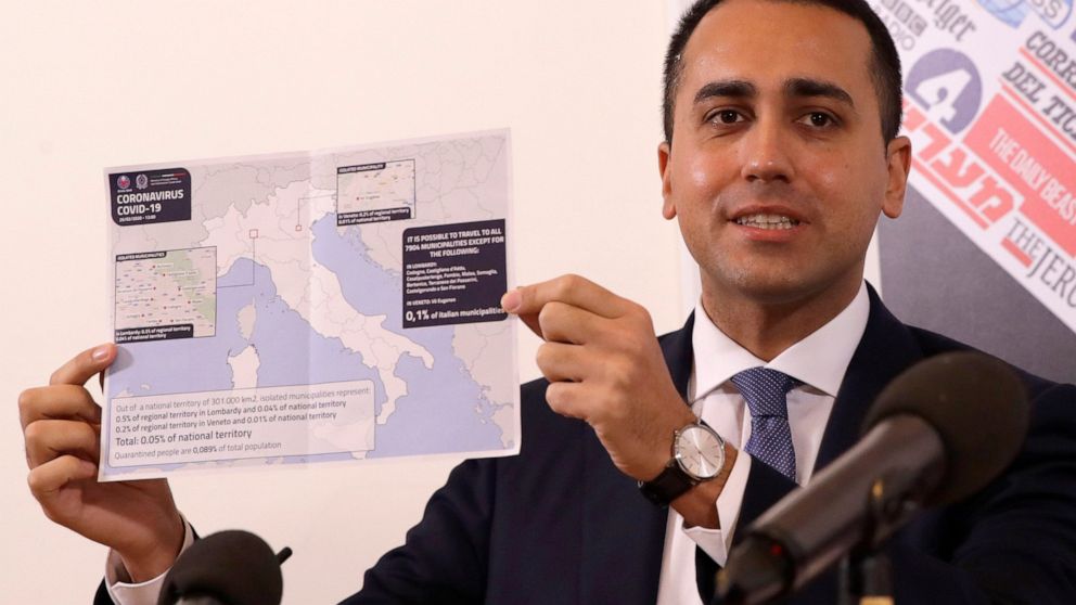 Italian Foreign Minister Luigi di Maio holds up a map of Italy showing the municipalities in regions of Lombardy and Veneto where it is not possible to travel, during a press conference at the foreign press association, in Rome, Thursday, Feb. 27, 20