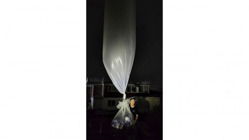 Park Sang-hak, a North Korean defector-turned-activist, holds to release a balloon bearing masks and medicines in the border town Gimpo, South Korea, Wednesday, July 6, 2022. The South Korea activist said Thursday he launched more huge balloons carry