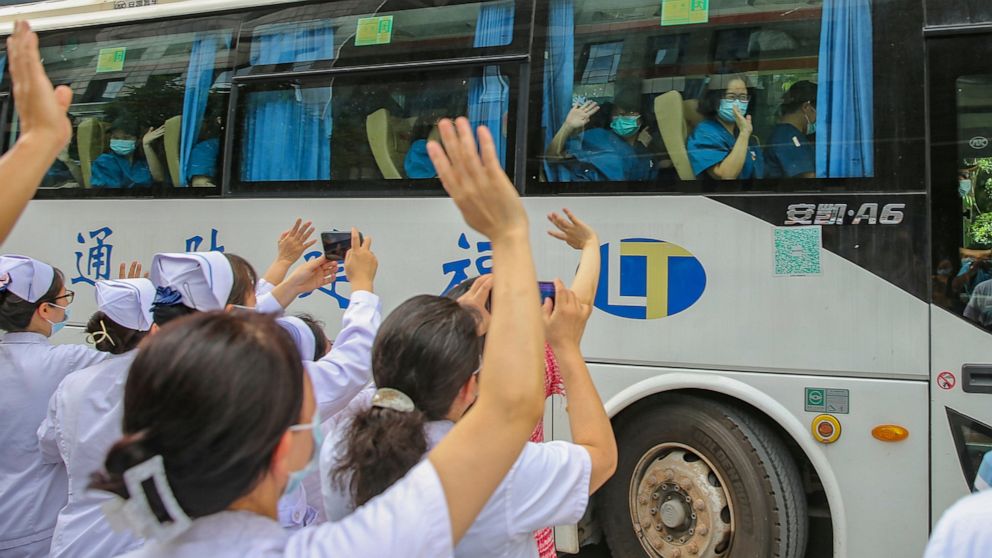 Medical workers send off their colleagues leaving to help with an outbreak of COVID-19 in Putian from a provincial hospital in Fuzhou in southeast China's Fujian province Sunday, Sept. 12, 2021. Putian, a city in southern China that is trying to cont