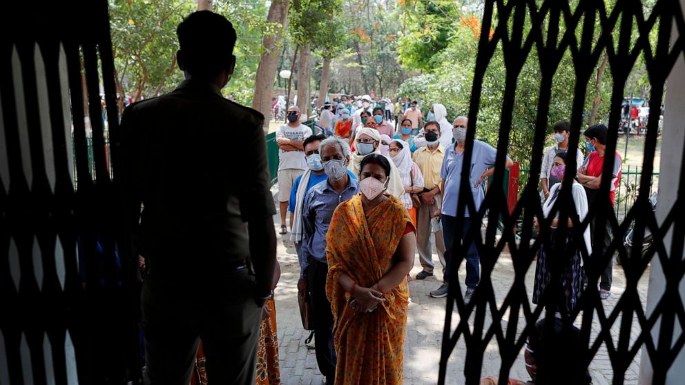 Indians line up to receive the vaccine for COVID-19 at a medical college in Prayagraj, India, Saturday, May 8, 2021. Two southern states in India became the latest to declare lockdowns, as coronavirus cases surge at breakneck speed across the country