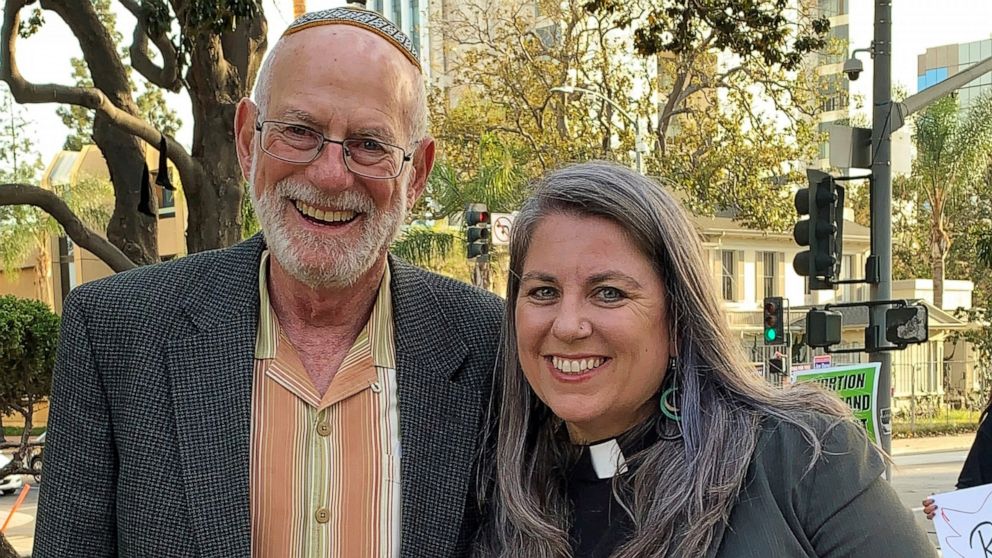 FILE - In this photo provided by Felicity Figueroa, Rabbi Stephen Einstein, left, founding rabbi of Congregation B'nai Tzedek in Fountain Valley, Calif., stands with the Rev. Sarah Halverson-Cano, senior pastor of Irvine United Congregational Church 
