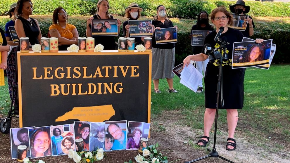 Rebecca Cerese, a policy advocate at the North Carolina Justice Center, speaks at a vigil in front of the North Carolina Legislative Building in Raleigh, N.C., Tuesday, July 26, 2022, to remember people lacking Medicaid coverage or insurance who have