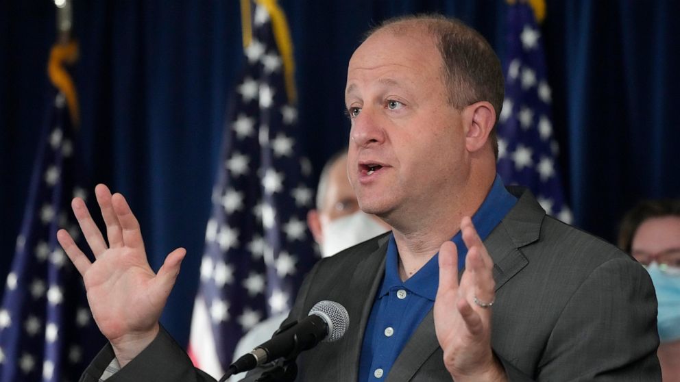 Colorado Gov. Jared Polis makes a point during a news conference about Colorado offering coronavirus vaccinations to children, Thursday, Oct. 28, 2021, in Denver. Colorado is also seeing an increase in overall coronavirus cases, which is putting stre