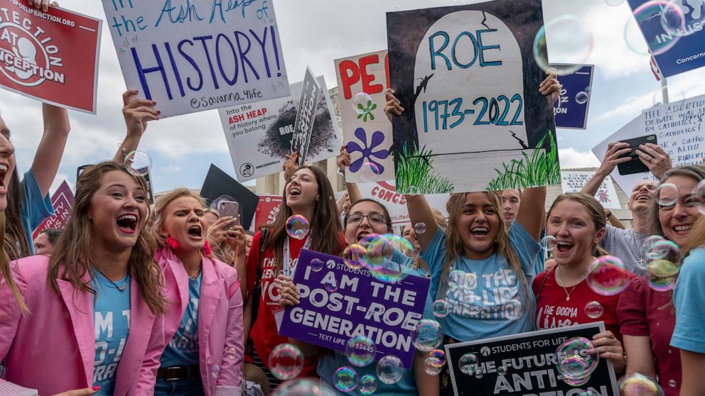 Anti-abortion protesters celebrate following Supreme Court's decision to overturn Roe v. Wade, federally protected right to abortion, outside the Supreme Court in Washington, Friday, June 24, 2022. The Supreme Court has ended constitutional protectio