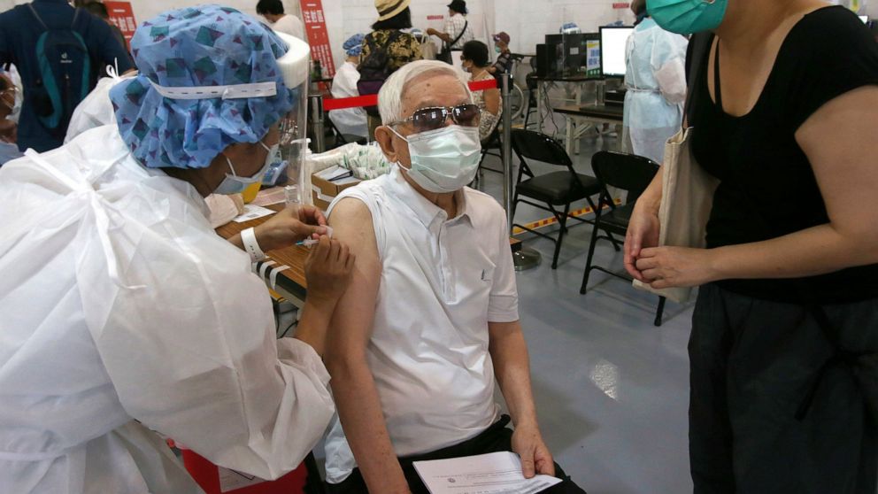 FILE - In this June 16, 2021, file photo, an elderly Taiwanese man receives a shot of the AstraZeneca COVID-19 vaccine at Songshan Cultural and Creative Park in Taipei, Taiwan. Taiwan is planning to take a regulatory shortcut that would allow vaccine