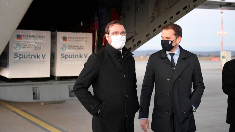 Slovak Prime Minister Igor Matovic, right, and Health Minister Marek Krajci at Kosice Airport, Slovakia, Monday March 1, 2021, as Russia's Sputnik V coronavirus vaccine arrives. Hard-hit Slovakia signed a deal to acquire 2 million dozes of Russia’s S