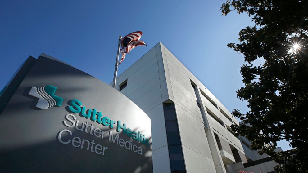 In this Friday, Sept. 20, 2019, photo, an American flag flutters in the breeze outside of the Sutter Medical Center in Sacramento, Calif. California Attorney General Xavier Becerra, along with 1,500 self-funded health plans, have sued Sutter Health f