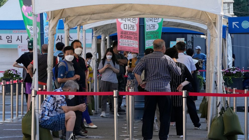People wait to get coronavirus testing at a testing site in Seoul, South Korea, Wednesday, July 21, 2021.(AP Photo/Ahn Young-joon)