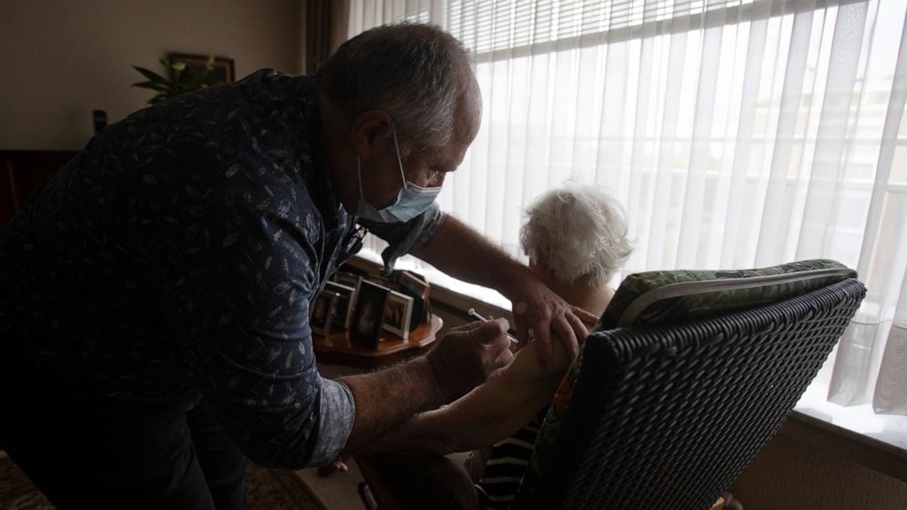 FILE - In this May 6, 2021 file photo, Belgian doctor Peter Theerens administers the Johnson & Johnson COVID-19 vaccine to an elderly patient during a house call in Antwerp, Belgium. The government warned Thursday, Oct. 21, 2021 that Belgium could we