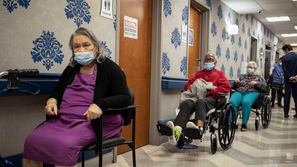 FILE - In this Friday, Jan. 15, 2021 file photo, nursing home residents wait on line to receive a COVID-19 vaccine at Harlem Center for Nursing and Rehabilitation in the Harlem neighborhood of New York. The Justice Department says it's decided agains