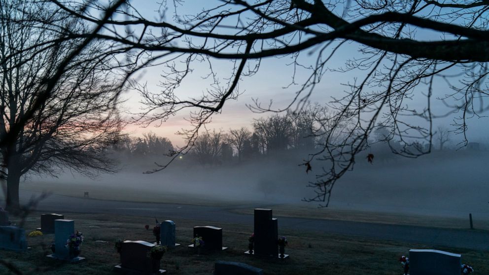 FILE - In this Wednesday, March 17, 2021 file photo, morning fog blankets a cemetery in West Virginia. The number of U.S. suicides fell nearly 6% in 2020 amid the coronavirus pandemic — the largest annual decline in at least four decades, according t
