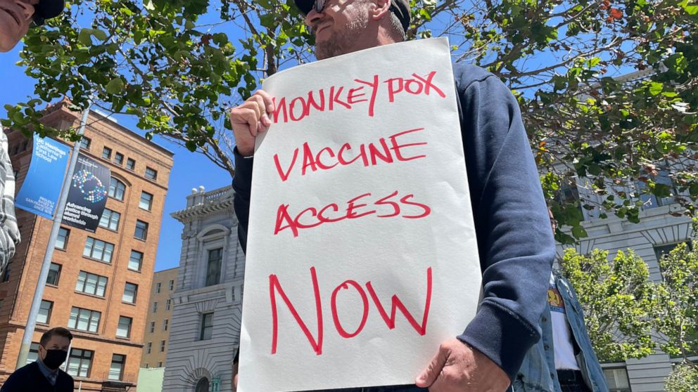 FILE - A man holds a sign urging increased access to the monkeypox vaccine during a protest in San Francisco, July 18, 2022. U.S. health officials on Tuesday, August 9, 2022, authorized a new monkeypox vaccination strategy designed to stretch limited