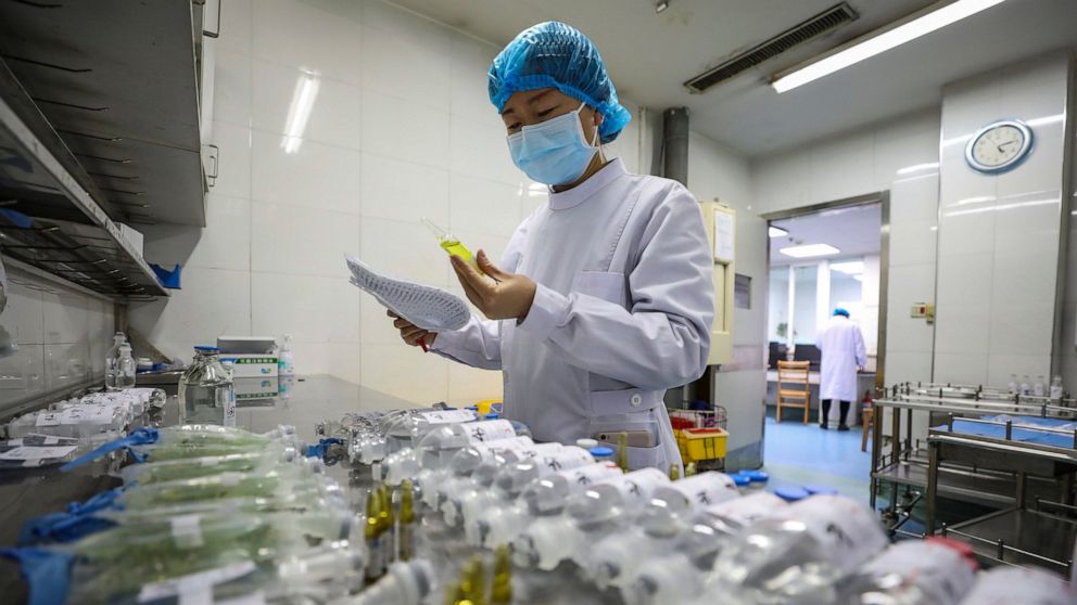In this Sunday, Feb. 16, 2020, photo, a nurse prepares medicines for patients at Jinyintan Hospital designated for new coronavirus infected patients, in Wuhan in central China's Hubei province. China reported thousands new virus cases and more deaths
