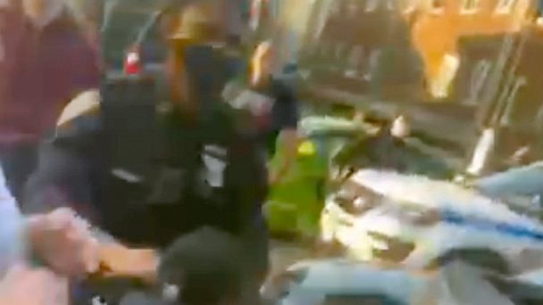 In this April 29, 2020 image made from video provided by Adegoke Atunbi, a New York City Police Officer in plain clothes wrestles a man to the ground while making an arrest in the Brooklyn borough of New York. The video is among those posted on socia