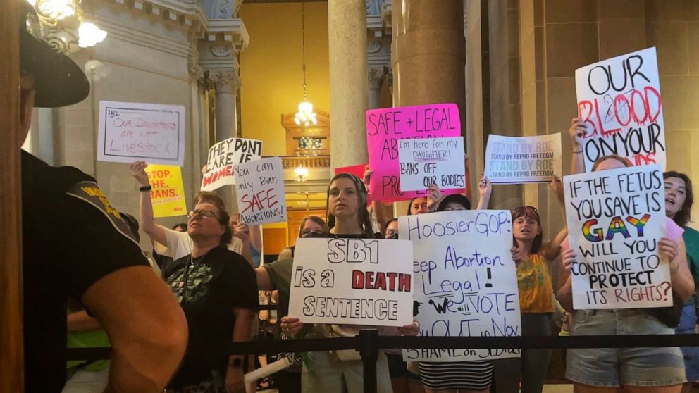 Abortion-rights protesters fill Indiana Statehouse corridors and cheer outside legislative chambers, Friday, Aug. 5, 2022, as lawmakers vote to concur on a near-total abortion ban, in Indianapolis. (AP Photo/Arleigh Rodgers)