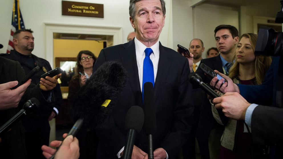 FILE - In a Feb. 6, 2019 file photo, North Carolina Gov. Roy Cooper speaks with reporters after testifying before the House Natural Resources Committee hearing on climate change, on Capitol Hill in Washington. North Carolina Republicans and their all