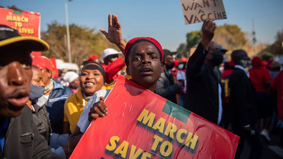 FILE — In this Friday, June 25, 2021 file photo members of the Economic Freedom Fighters stage a protest march in Pretoria, South Africa, demanding that vaccines from China and Russia be included in the country's vaccine rollout program. The African 