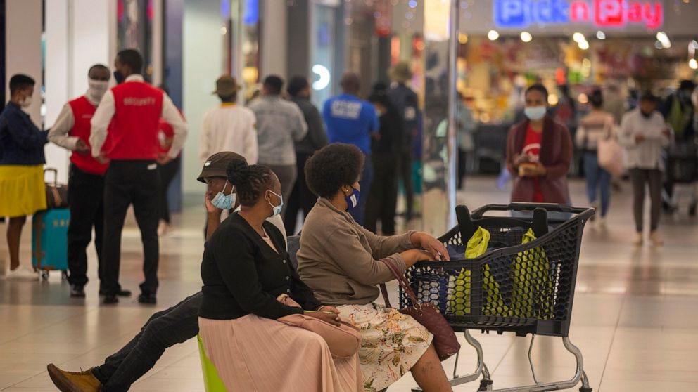 People shop in a mall, in Johannesburg, South Africa, Friday Nov. 26, 2021. Advisers to the World Health Organization are holding a special session Friday to flesh out information about a worrying new variant of the coronavirus that has emerged in So