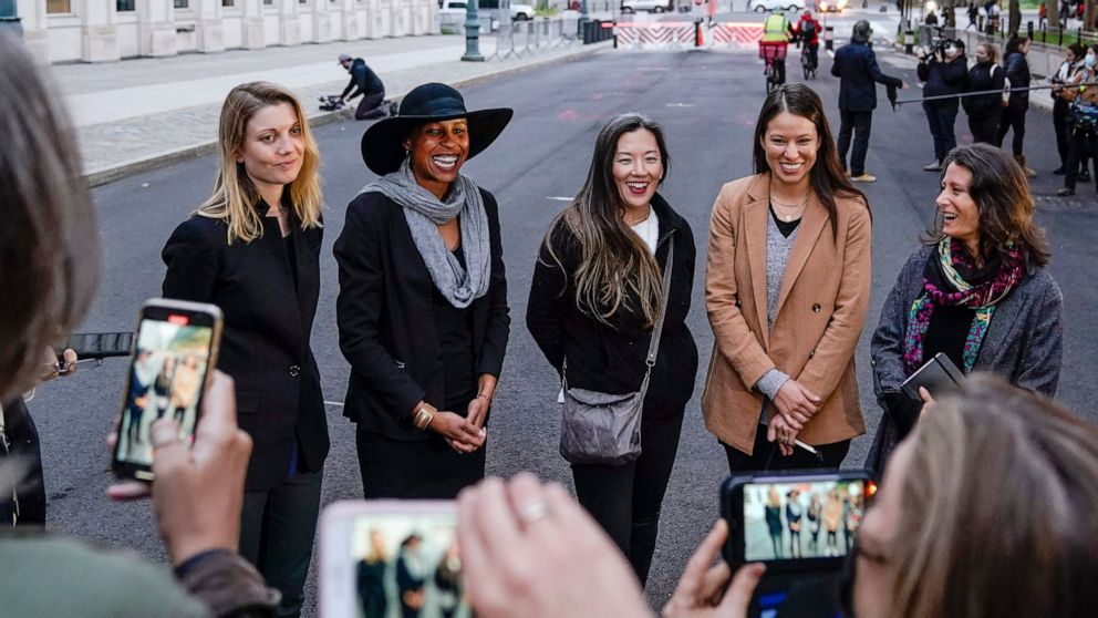 FILE — In this Oct. 27. 2020 file photo, Nicki Clyne, left, Michelle Hatchette, second from left, Linda Chung, center, and Dr. Danielle Roberts, right, speak outside Brooklyn federal court following the sentencing hearing for self-improvement guru Ke