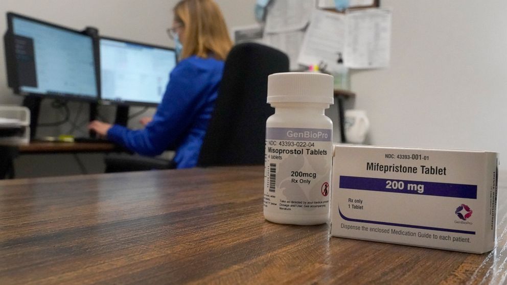 A Nurse Practitioner works in an office at a Planned Parenthood clinic where she confers via teleconference with patients seeking self-managed abortions as containers of the medication used to end an early pregnancy sits on a table nearby Friday, Oct