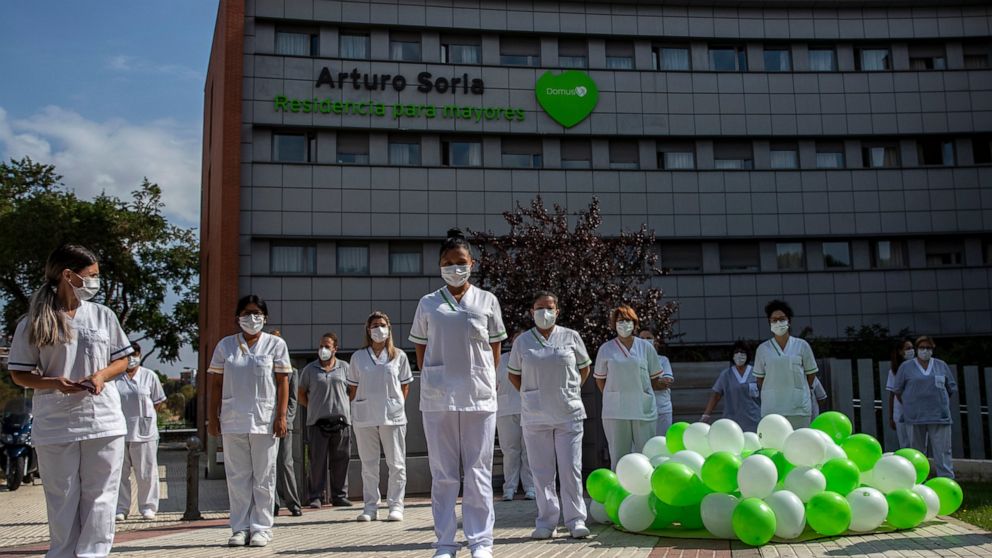Workers of a nursing home "DomusVi Arturo Soria" hold a minute of silence in support of the social and health sector and its workers in Madrid, Spain, Tuesday, Sept. 15, 2020. After ending a strict lockdown in June having brought under control the vi
