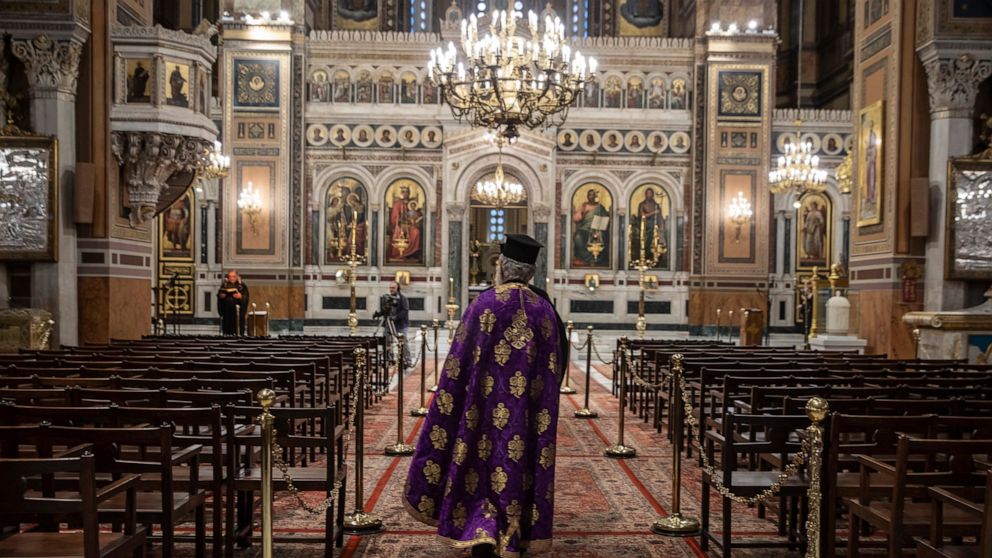 In this Monday, April 13, 2020, photo a priest takes part in a Holy Monday ceremony held without worshippers at the Athens Cathedral, in Greece, during a lockdown order by the government to prevent the spread of the coronavirus. For Orthodox Christia